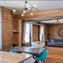 Exposed brick living space with black pendant light fixture
